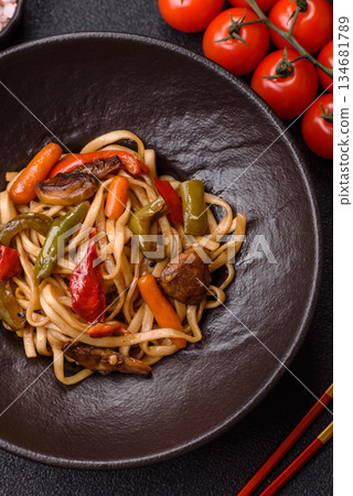 Asian food, noodles with vegetables, vegetarian dish with spicy sauce. Noodles with vegetables Asian food, noodles with vegetables, vegetarian dish with spicy sauce. Noodles with vegetables 134681789