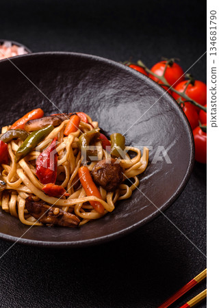 Asian food, noodles with vegetables, vegetarian dish with spicy sauce. Noodles with vegetables Asian food, noodles with vegetables, vegetarian dish with spicy sauce. Noodles with vegetables 134681790
