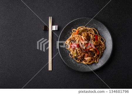 Asian food, noodles with vegetables, vegetarian dish with spicy sauce. Noodles with vegetables Asian food, noodles with vegetables, vegetarian dish with spicy sauce. Noodles with vegetables 134681796