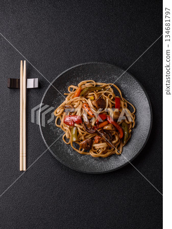 Asian food, noodles with vegetables, vegetarian dish with spicy sauce. Noodles with vegetables Asian food, noodles with vegetables, vegetarian dish with spicy sauce. Noodles with vegetables 134681797