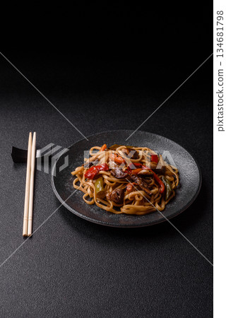 Asian food, noodles with vegetables, vegetarian dish with spicy sauce. Noodles with vegetables Asian food, noodles with vegetables, vegetarian dish with spicy sauce. Noodles with vegetables 134681798