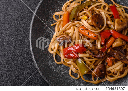Asian food, noodles with vegetables, vegetarian dish with spicy sauce. Noodles with vegetables Asian food, noodles with vegetables, vegetarian dish with spicy sauce. Noodles with vegetables 134681807