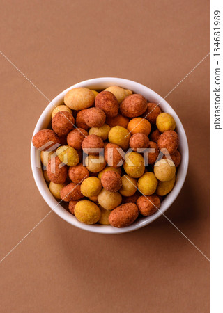 Food, nuts coated with salt and paprika, peanuts as a source of protein. Salted peanuts Food, nuts coated with salt and paprika, peanuts as a source of protein. Salted peanuts 134681989