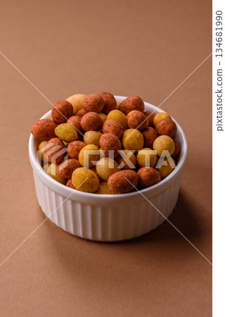 Food, nuts coated with salt and paprika, peanuts as a source of protein. Salted peanuts 134681990