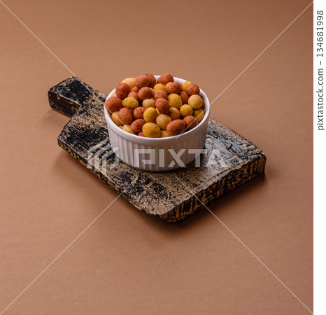 Food, nuts coated with salt and paprika, peanuts as a source of protein. Salted peanuts 134681998