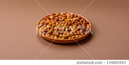Food, nuts coated with salt and paprika, peanuts as a source of protein. Salted peanuts Food, nuts coated with salt and paprika, peanuts as a source of protein. Salted peanuts 134682003
