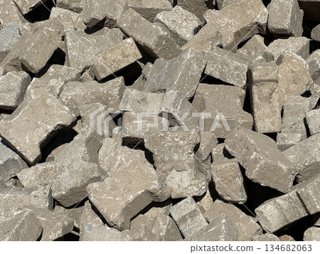 Pile of gray concrete blocks used in construction background 134682063