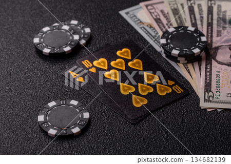 Playing blackjack or baccarat card game in casino with chips. Cards and chips on black felt Playing blackjack or baccarat card game in casino with chips. Cards and chips on black felt 134682139