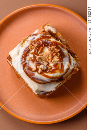 Cinnabon, a sweet cinnamon pastry, a high calorie bun or roll. Cinnabon with cinnamon 134682184