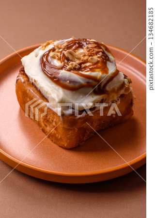 Cinnabon, a sweet cinnamon pastry, a high calorie bun or roll. Cinnabon with cinnamon 134682185