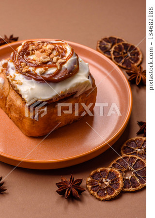 Cinnabon, a sweet cinnamon pastry, a high calorie bun or roll. Cinnabon with cinnamon 134682188