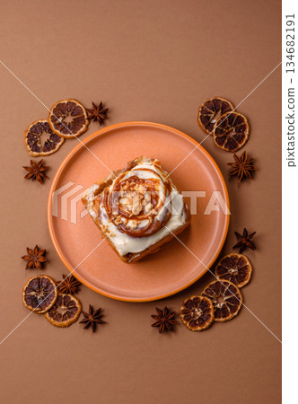 Cinnabon, a sweet cinnamon pastry, a high calorie bun or roll. Cinnabon with cinnamon 134682191