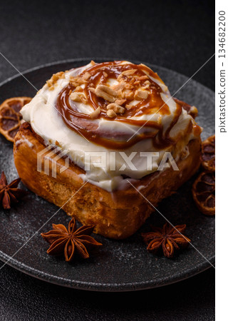 Cinnabon, a sweet cinnamon pastry, a high calorie bun or roll. Cinnabon with cinnamon Cinnabon, a sweet cinnamon pastry, a high calorie bun or roll. Cinnabon with cinnamon 134682200