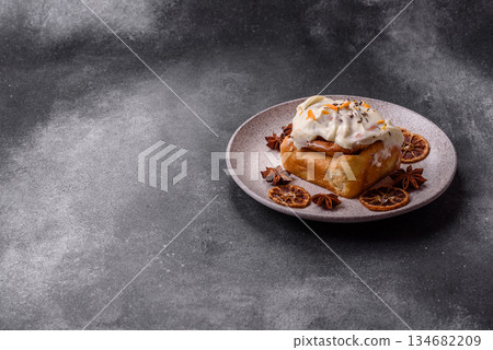 Cinnabon, a sweet cinnamon pastry, a high calorie bun or roll. Cinnabon with cinnamon 134682209