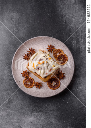 Cinnabon, a sweet cinnamon pastry, a high calorie bun or roll. Cinnabon with cinnamon 134682211