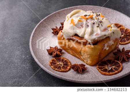 Cinnabon, a sweet cinnamon pastry, a high calorie bun or roll. Cinnabon with cinnamon 134682213
