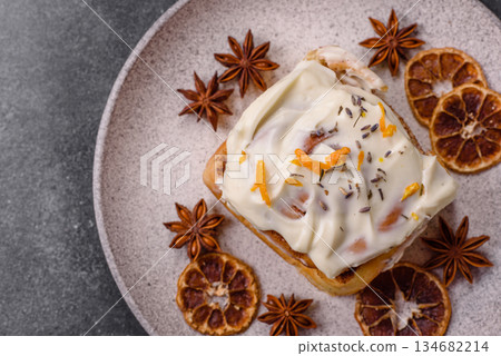 Cinnabon, a sweet cinnamon pastry, a high calorie bun or roll. Cinnabon with cinnamon 134682214