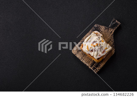 Cinnabon, a sweet cinnamon pastry, a high calorie bun or roll. Cinnabon with cinnamon Cinnabon, a sweet cinnamon pastry, a high calorie bun or roll. Cinnabon with cinnamon 134682226