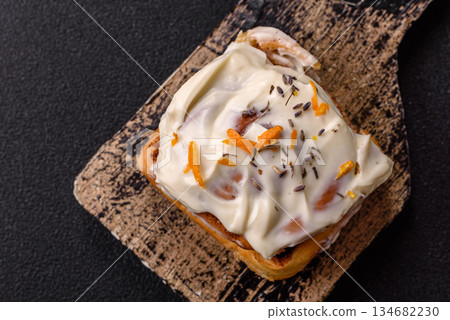 Cinnabon, a sweet cinnamon pastry, a high calorie bun or roll. Cinnabon with cinnamon Cinnabon, a sweet cinnamon pastry, a high calorie bun or roll. Cinnabon with cinnamon 134682230