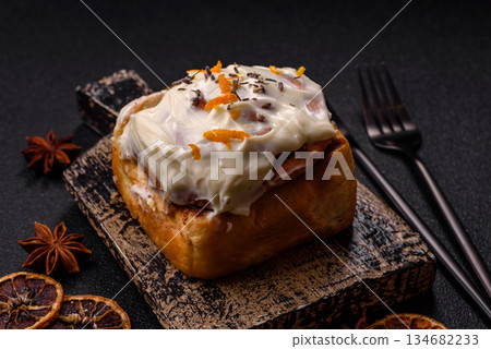 Cinnabon, a sweet cinnamon pastry, a high calorie bun or roll. Cinnabon with cinnamon 134682233