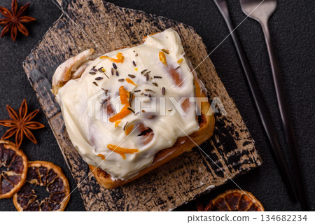 Cinnabon, a sweet cinnamon pastry, a high calorie bun or roll. Cinnabon with cinnamon 134682234