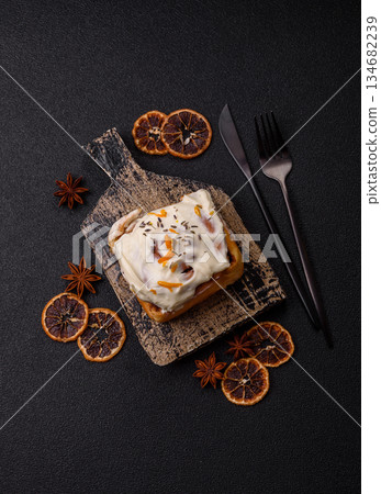 Cinnabon, a sweet cinnamon pastry, a high calorie bun or roll. Cinnabon with cinnamon 134682239