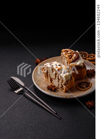 Cinnabon, a sweet cinnamon pastry, a high calorie bun or roll. Cinnabon with cinnamon Cinnabon, a sweet cinnamon pastry, a high calorie bun or roll. Cinnabon with cinnamon 134682244