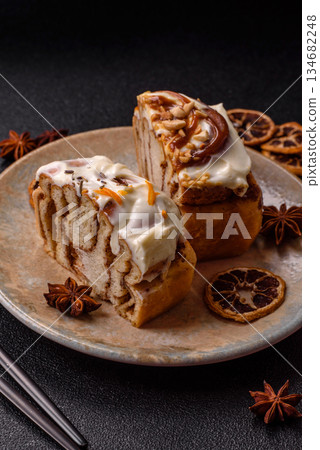 Cinnabon, a sweet cinnamon pastry, a high calorie bun or roll. Cinnabon with cinnamon Cinnabon, a sweet cinnamon pastry, a high calorie bun or roll. Cinnabon with cinnamon 134682248