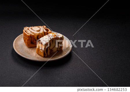 Cinnabon, a sweet cinnamon pastry, a high calorie bun or roll. Cinnabon with cinnamon Cinnabon, a sweet cinnamon pastry, a high calorie bun or roll. Cinnabon with cinnamon 134682253