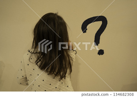 A child tilting his head in doubt A child tilting his head in doubt 134682308