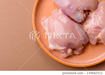 Chicken thigh fillet, skinless and boneless meat for grilling or barbecue. Chicken thigh fillet Chicken thigh fillet, skinless and boneless meat for grilling or barbecue. Chicken thigh fillet 134682511