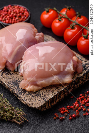 Chicken thigh fillet, skinless and boneless meat for grilling or barbecue. Chicken thigh fillet Chicken thigh fillet, skinless and boneless meat for grilling or barbecue. Chicken thigh fillet 134682549