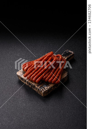 Smoked cabanossi, thin salami sausage, meat sticks, or snacks. Cabanossi sausage Smoked cabanossi, thin salami sausage, meat sticks, or snacks. Cabanossi sausage 134682706