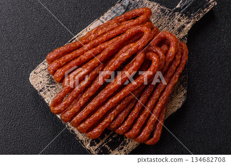 Smoked cabanossi, thin salami sausage, meat sticks, or snacks. Cabanossi sausage 134682708