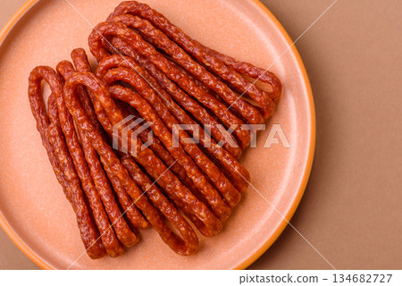 Smoked cabanossi, thin salami sausage, meat sticks, or snacks. Cabanossi sausage 134682727