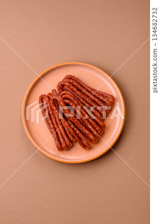 Smoked cabanossi, thin salami sausage, meat sticks, or snacks. Cabanossi sausage 134682732