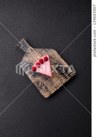 Raspberry or strawberry cheesecake, a slice of sweet red cake with berries. Raspberry cheesecake Raspberry or strawberry cheesecake, a slice of sweet red cake with berries. Raspberry cheesecake 134683007