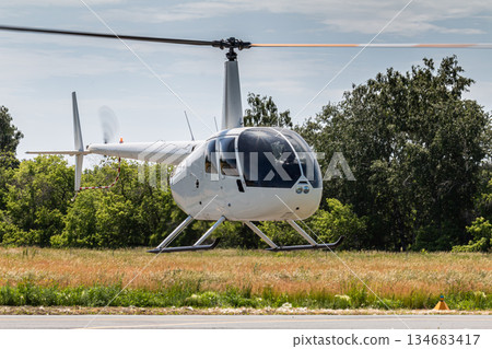 landing of a small white helicopter landing of a small white helicopter 134683417