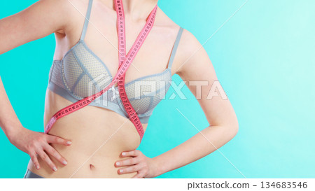 Woman in underwear with measure tape 134683546