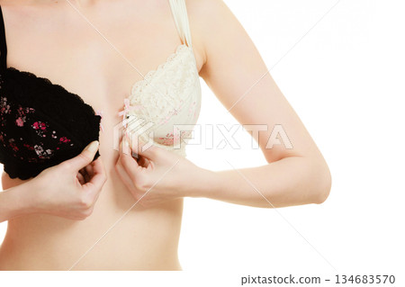 Lady with choice trying to choose perfect bra. Lady with choice trying to choose perfect bra. 134683570