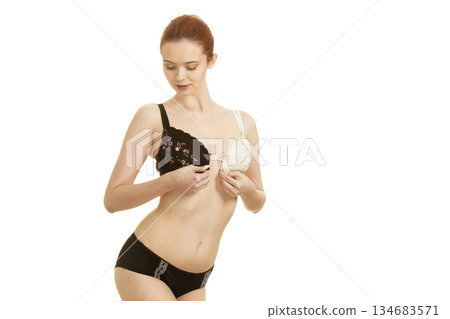 Girl of smooth body with brassiere dilemma. 134683571