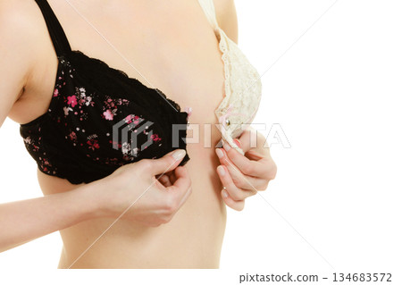 Lady with choice trying to choose perfect bra. 134683572
