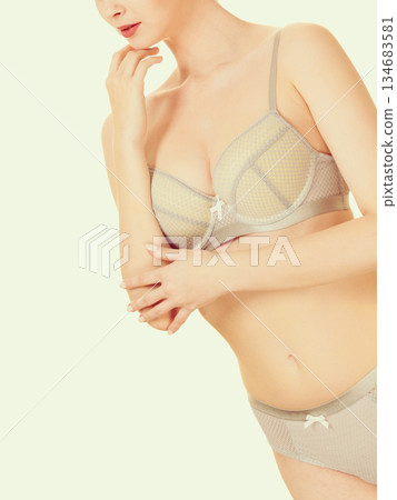 Attractive slim woman in grey matching underwear Attractive slim woman in grey matching underwear 134683581