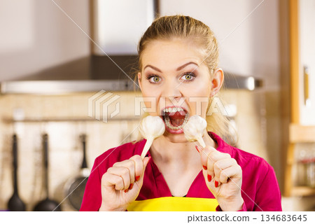 Crazy girl eating garlic vegetable 134683645