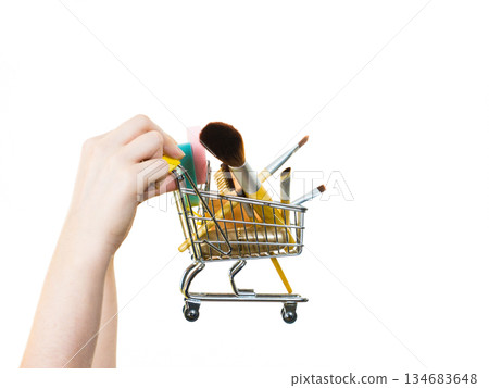 Woman holding shopping cart with make up brushes 134683648