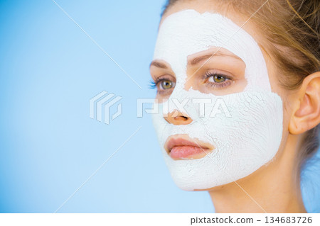 Girl with dry white mud mask on face Girl with dry white mud mask on face 134683726