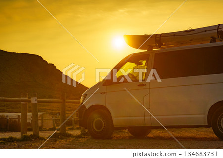 Car with canoe on top roof at sunset Car with canoe on top roof at sunset 134683731