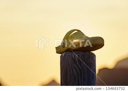 Shoes clogs outdoors against sunset light 134683732