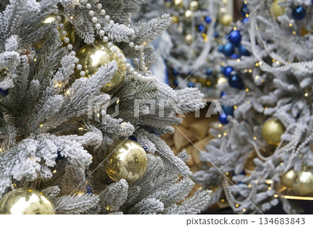 Spruce tree with christmas balls on branches. 134683843