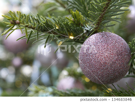 Spruce tree with christmas balls on branches. 134683846
